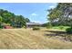 Home exterior showcasing the spacious lawn and a covered carport at 668 Spring Place Ne Rd, White, GA 30184