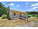 Inviting home with a covered front porch and mature trees, perfect for relaxing outdoors at 668 Spring Place Ne Rd, White, GA 30184