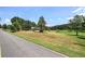 Exterior of a home with a large yard, mature trees and a road nearby at 668 Spring Place Ne Rd, White, GA 30184
