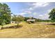 Large yard with a home, shed, mature trees, and covered area at 668 Spring Place Ne Rd, White, GA 30184