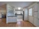 Bright kitchen with white cabinets, hardwood floors, and stainless steel appliances at 668 Spring Place Ne Rd, White, GA 30184