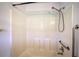 Shower with white tile walls and a modern showerhead with a grab bar at 668 Spring Place Ne Rd, White, GA 30184
