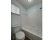 Well-lit bathroom with a bathtub, tiled shower, and a toilet, featuring modern fixtures and a clean design at 8249 Creekline Ct, Riverdale, GA 30274