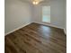 Bedroom featuring hardwood floors and a window for natural light, creating a bright and spacious atmosphere at 8249 Creekline Ct, Riverdale, GA 30274
