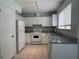 Cozy kitchen with granite countertops, tiled floors, and white cabinets and appliances at 8249 Creekline Ct, Riverdale, GA 30274
