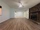 Spacious living room featuring new wood flooring and a striking stone fireplace at 8249 Creekline Ct, Riverdale, GA 30274