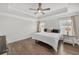 This bedroom offers a tray ceiling, fan, hardwood floors, two windows and neutral paint at 2530 Clairebrooke Bend, Atlanta, GA 30341