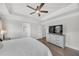 This bedroom features hardwood floors, tray ceiling, fan and an ensuite bathroom at 2530 Clairebrooke Bend, Atlanta, GA 30341