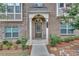 Inviting front entrance with detailed trim and neatly landscaped garden beds at 2530 Clairebrooke Bend, Atlanta, GA 30341