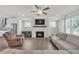 Bright, open living room with a fireplace, ceiling fan and ample natural light at 2530 Clairebrooke Bend, Atlanta, GA 30341