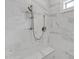 Close-up of the marble-tiled walk-in shower with shower head at 2530 Clairebrooke Bend, Atlanta, GA 30341