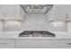 Close-up of the stovetop, showing the sleek design and modern vent hood at 2530 Clairebrooke Bend, Atlanta, GA 30341