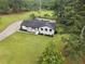 Aerial view of a single-Gathering home, black roof, white paint, and an in-ground pool at 2827 Highway 138 Ne, Conyers, GA 30013