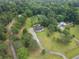 An aerial view showing a beautiful homesite surrounded by many mature trees at 2827 Highway 138 Ne, Conyers, GA 30013
