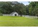 Charming barn with a white fence, surrounded by lush greenery at 2827 Highway 138 Ne, Conyers, GA 30013