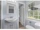 Bathroom featuring a stylish vanity, mirror, modern fixtures, and herringbone floor at 2827 Highway 138 Ne, Conyers, GA 30013
