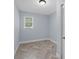 Small bedroom with a window, closet, and herringbone floors at 2827 Highway 138 Ne, Conyers, GA 30013
