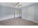 Bright bedroom showcases a herringbone floor, closet, and a ceiling fan at 2827 Highway 138 Ne, Conyers, GA 30013