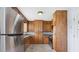 Kitchen featuring stainless steel appliances, wooden cabinets, and herringbone-patterned floors at 2827 Highway 138 Ne, Conyers, GA 30013