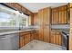 Charming kitchen featuring wooden cabinets, stainless steel appliances, and bright herringbone floors at 2827 Highway 138 Ne, Conyers, GA 30013