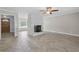 Open-concept living area with herringbone floors, fireplace, and a view of the entry and front windows at 2827 Highway 138 Ne, Conyers, GA 30013