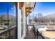 Exterior view of a balcony with wood decking and ornate wooden beams, looking out at a park at 350 Olmstead Way # 29, Alpharetta, GA 30022