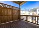 Balcony view of surrounding homes with wooden privacy fence and a wooden railing at 350 Olmstead Way # 29, Alpharetta, GA 30022