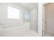 Bright bathroom showcasing soaking tub and glass shower with subway tile surround at 350 Olmstead Way # 29, Alpharetta, GA 30022