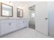 Bright bathroom featuring a double vanity with white cabinets and marble floors, adjacent to the main bedroom at 350 Olmstead Way # 29, Alpharetta, GA 30022