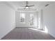 Spacious bedroom with tray ceilings, ceiling fan, and a door leading to a balcony at 350 Olmstead Way # 29, Alpharetta, GA 30022