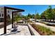 Inviting community area with a swing and meticulous landscaping and views of townhomes on a beautiful day at 350 Olmstead Way # 29, Alpharetta, GA 30022