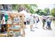 Outdoor farmers market, featuring deGraan Farms, with people browsing vendor stalls at 350 Olmstead Way # 29, Alpharetta, GA 30022