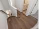Hallway featuring hardwood floors leading to a bathroom and staircase at 350 Olmstead Way # 29, Alpharetta, GA 30022