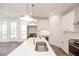 Bright kitchen with white cabinetry, a large island, and stainless steel appliances, ideal for cooking and entertaining at 350 Olmstead Way # 29, Alpharetta, GA 30022