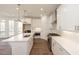Modern kitchen featuring white cabinetry, quartz countertops, stainless steel appliances, and hardwood floors at 350 Olmstead Way # 29, Alpharetta, GA 30022