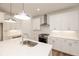 Bright kitchen with stainless steel appliances, a center island, pendant lights, and white cabinets at 350 Olmstead Way # 29, Alpharetta, GA 30022