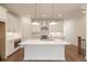 Open kitchen design boasts center island, stainless steel appliances, and sleek white cabinets at 350 Olmstead Way # 29, Alpharetta, GA 30022