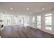 Bright, open-concept living room with hardwood floors, lots of windows, and a fireplace at 350 Olmstead Way # 29, Alpharetta, GA 30022