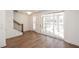 Open concept living area with wood floors, staircase, and sliding glass doors leading to an outdoor patio at 350 Olmstead Way # 29, Alpharetta, GA 30022