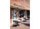 Outdoor seating at South Main Kitchen, featuring brick building and sidewalk tables at 350 Olmstead Way # 29, Alpharetta, GA 30022