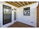 Covered patio with wood decking, white siding, black trim, and view of the outdoor area at 350 Olmstead Way # 29, Alpharetta, GA 30022