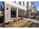 Covered outdoor patio with brick columns and flooring, recessed lighting, and sliding glass doors at 350 Olmstead Way # 29, Alpharetta, GA 30022