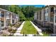 Beautiful townhome exteriors overlooking manicured lawn, landscaping and a walkway at 350 Olmstead Way # 29, Alpharetta, GA 30022
