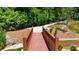 Quaint wooden walking bridge overlooking a pond amidst lush greenery along the landscaped path at 350 Olmstead Way # 29, Alpharetta, GA 30022