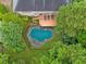 Aerial view of backyard featuring a covered pool, deck with chairs, and lush landscaping at 1488 Lachona Ne Ct, Atlanta, GA 30329