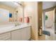 Bathroom showcasing a white vanity, a large mirror, and a view to a bright room at 1488 Lachona Ne Ct, Atlanta, GA 30329
