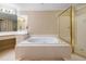 Bathroom showcasing a soaking tub, glass-enclosed shower, vanity with white cabinets, and neutral walls at 1488 Lachona Ne Ct, Atlanta, GA 30329