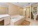 Bathroom featuring a soaking tub with jets, a glass enclosed shower, and a vanity with white cabinets at 1488 Lachona Ne Ct, Atlanta, GA 30329