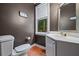 Small, stylish bathroom with a modern vanity, wood floors, and a window at 1488 Lachona Ne Ct, Atlanta, GA 30329