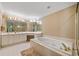 Bright bathroom features white cabinets, a soaking tub, and a seamless glass shower at 1488 Lachona Ne Ct, Atlanta, GA 30329